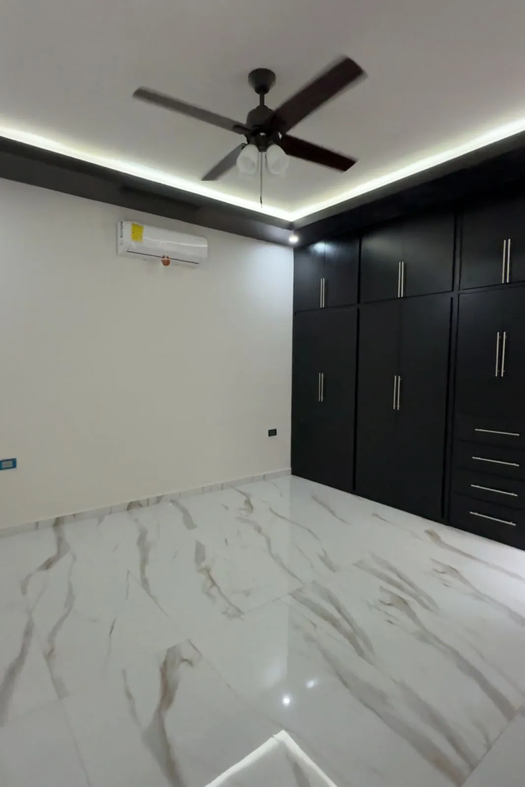 Recámara amplia con armario negro, minisplit y ventilador de techo, Santa Bárbara Residencial